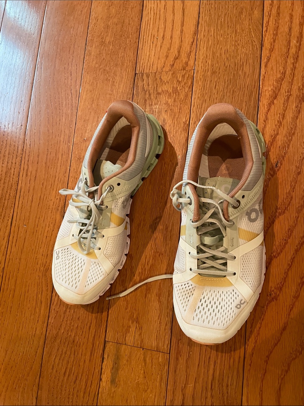 On Running Women's Trainers in White and Tan with Earthtone Accents